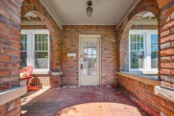 Covered brick porch looking toward the front door