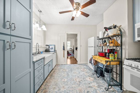 Kitchen with gas range and pantry cabinets