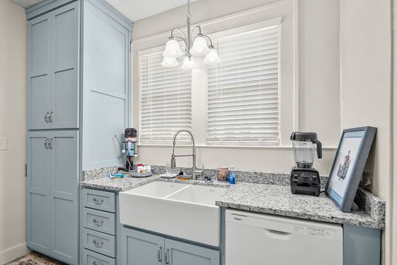 Farmhouse sink, granite counters and painted cabinetry