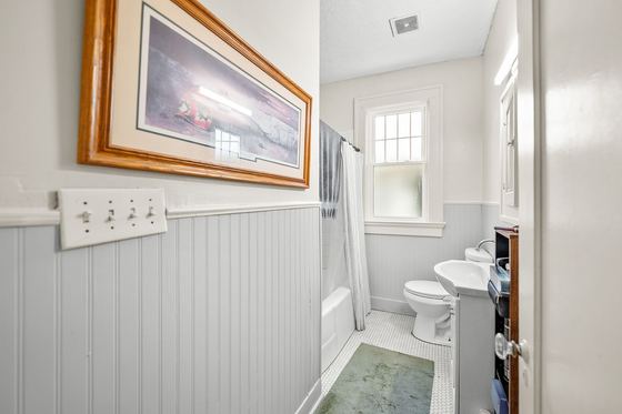 Full bath with beadboard wainscot