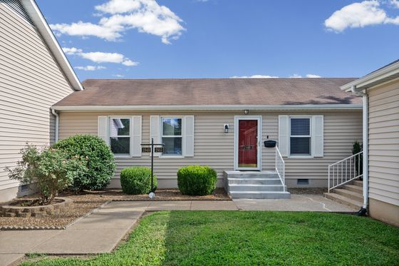 Front entry of 2949 Pawnee Drive, an attached one-story unit with a red door