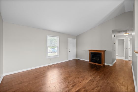 Living room with gas fireplace and vaulted ceiling
