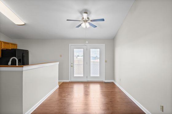 Living and dining area with French doors to the back deck