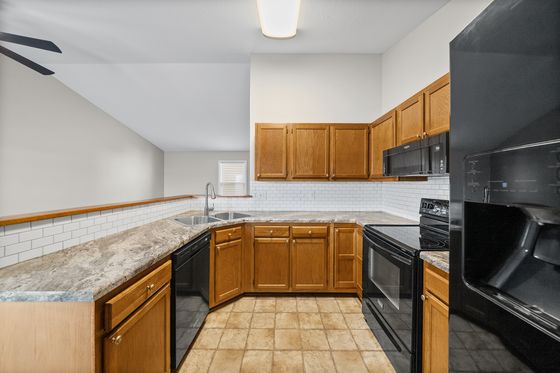 Kitchen with oak cabinetry and range