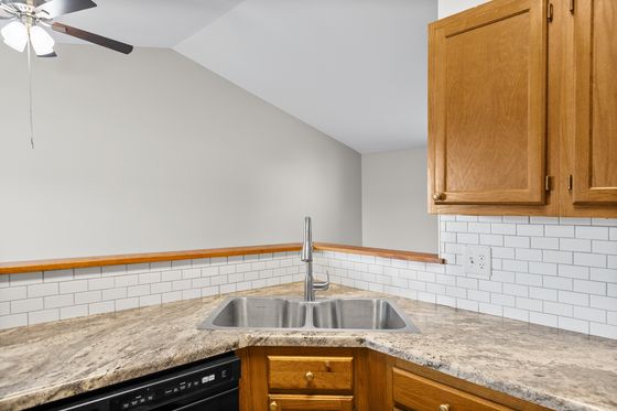 Kitchen sink and granite counter with breakfast bar
