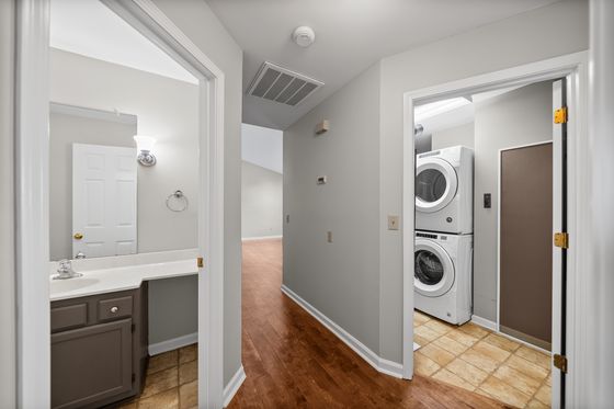 Hallway with vanity alcove and laundry closet