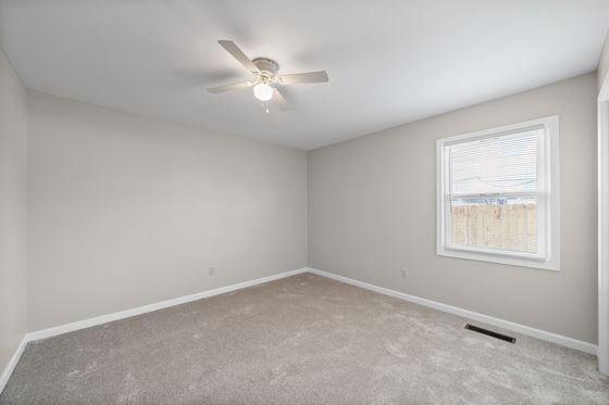 Second bedroom with window and ceiling fan