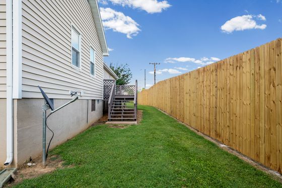 Fenced side yard alongside the home