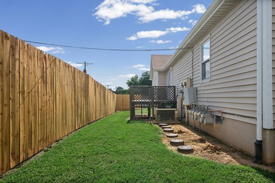 Fenced rear yard and deck behind the home