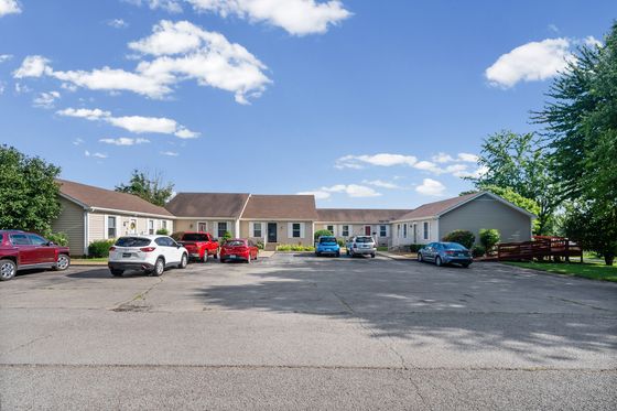 Shared paved parking area in front of the row of units
