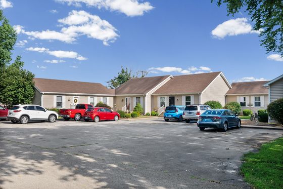 Parking area and front of the building from the drive