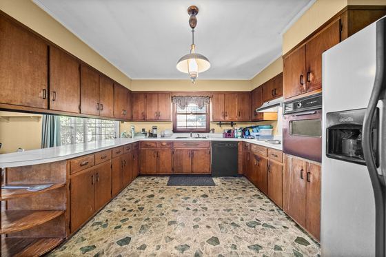 Kitchen: the original wood cabinetry, built-in wall oven, 5525 Glass Lane