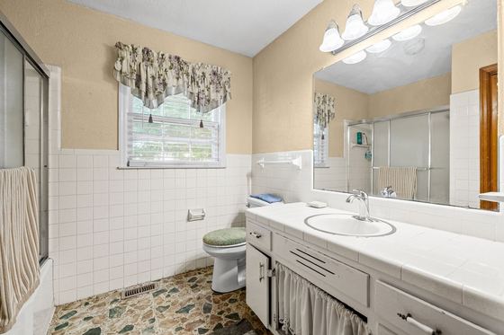 Full bath with a glass shower enclosure and long vanity, 5525 Glass Lane