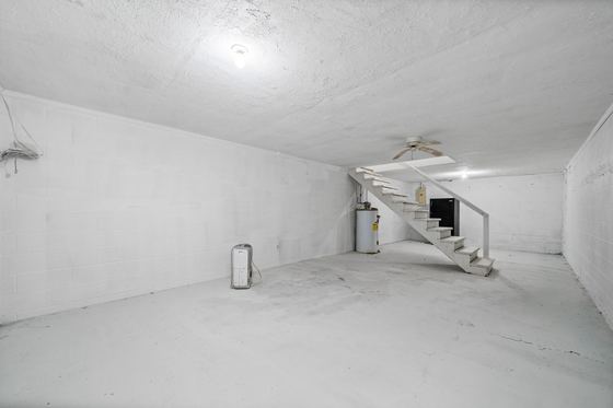 The basement - open, lit, concrete floor, with its own stairway, 5525 Glass Lane