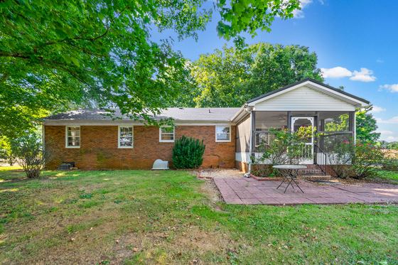 Back of the house: brick patio and the screened porch, 5525 Glass Lane