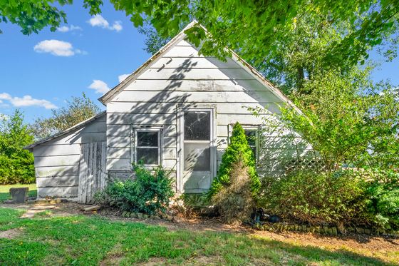 Older frame outbuilding with a metal roof, 5525 Glass Lane