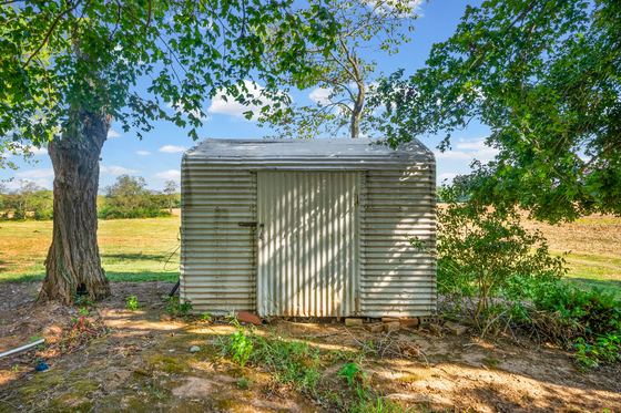 Metal storage shed under the trees, 5525 Glass Lane
